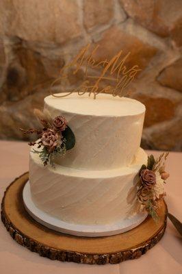 Two-tier, white wedding cake with flower cake toppers