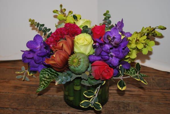 One of our usual boring flat and crowded arrangement of short stemmed blooms of garish color.