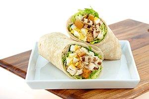 CHICKEN CAESAR WRAP: chopped romaine & iceberg blend, all-natural chicken, chopped eggs, croutons, and parmesan cheese.