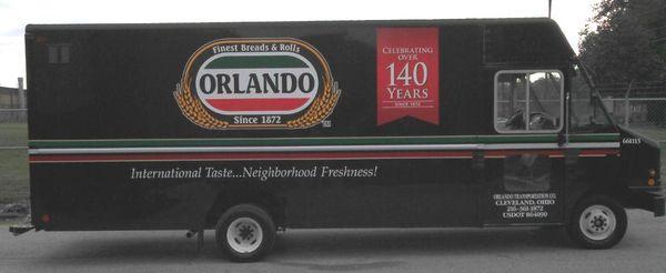 A delivery truck filled with freshly baked breads and rolls