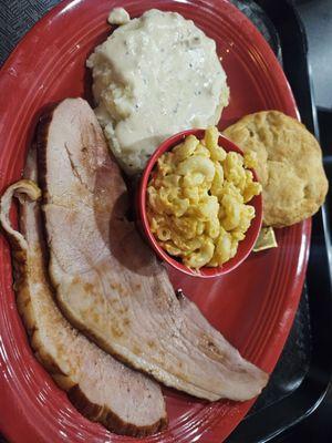 Ham, potatoes,  macaroni and cheese,  with a biscuit.