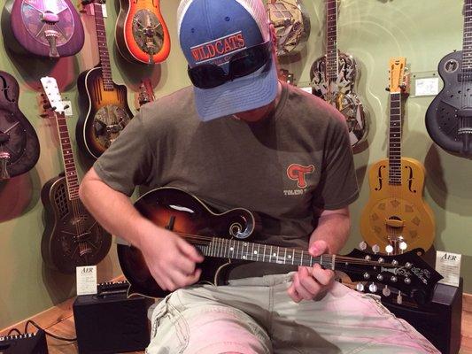 Playing the Gibson F5-G.