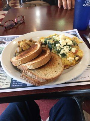 Three-egg omelette with spinach, tomatoes, mushrooms and feta cheese.