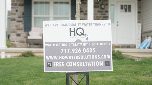 HQ Water Solutions sign in front of a satisfied customer's home