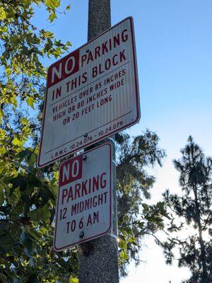 Parking signs on a streetlight