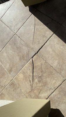 Cracked tiles showing addition separating from the house.