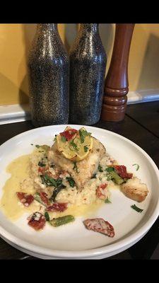 Chilean Sea bass over sun dried asparagus spinach risotto