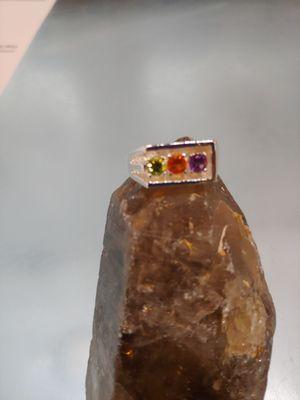 Man's ring with peridot, mexican opal, and amythest stones