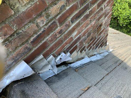 BEFORE - Deteriorated/damaged chimney flashing