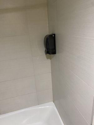 There's a empty hand sanitizer dispenser in the bathtub