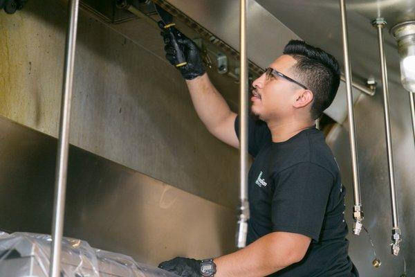 Guardian Technician cleaning a customers kitchen exhaust system.