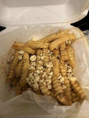 Loaded Greek fries with seasoning salt, Feta and Greek dressing.