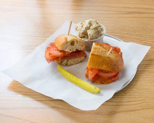 Italian ciabatta, salami, pepperoni, German baloney, tomato,sweet onion with side of house Italian dressing, pickle and one side