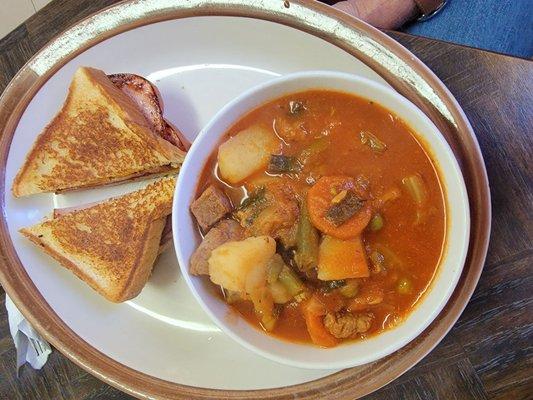 Delicious ham and cheese sandwich and soup.