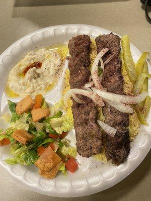 Kabab meal with side of salad and hummus