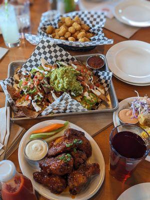 Wings, nachos and guac, corn ribs, tater tots