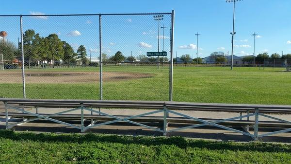 Baseball fields are equipped with lots of bleachers.