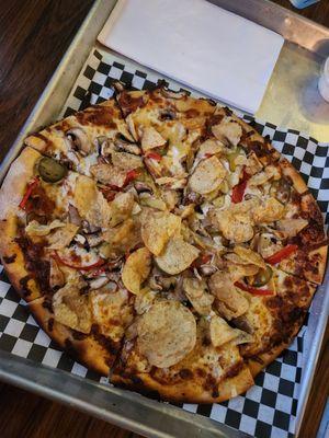 Chef's special veggie pizza -- garlic, pickles, jalapeños, bell peppers, mushroom, pineapple, and jalapeño kettle chips