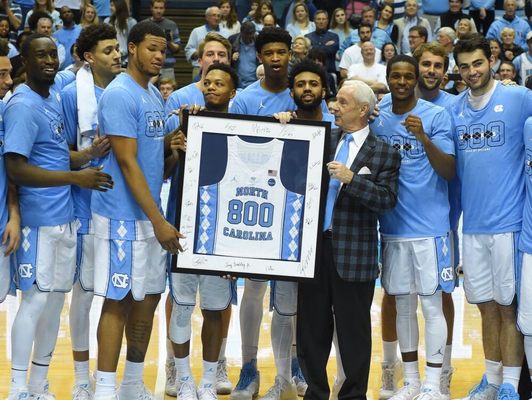 Roy Williams receives his 800 Wins Jersey specially framed by the Frame & Print Shop of Chapel Hill staff