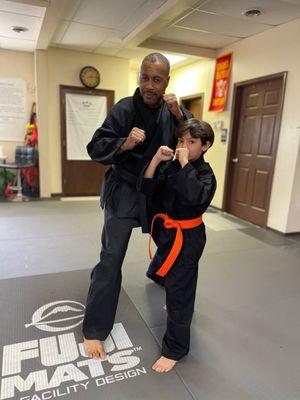 My son with Master Yusuf Muhammad after he received his orange belt in Karate! #kongfu #karate