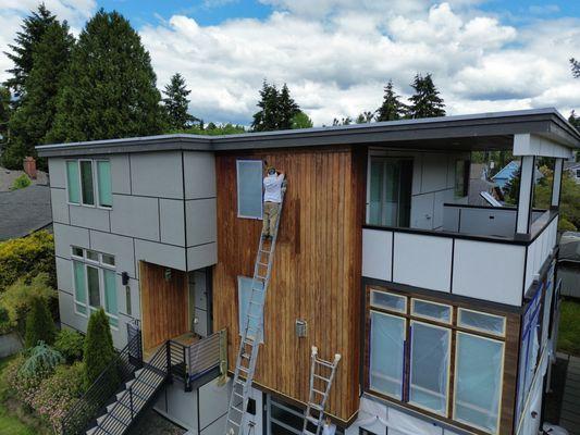 A Soudn Painting Solutions employee prepping an exterior home to be stained.