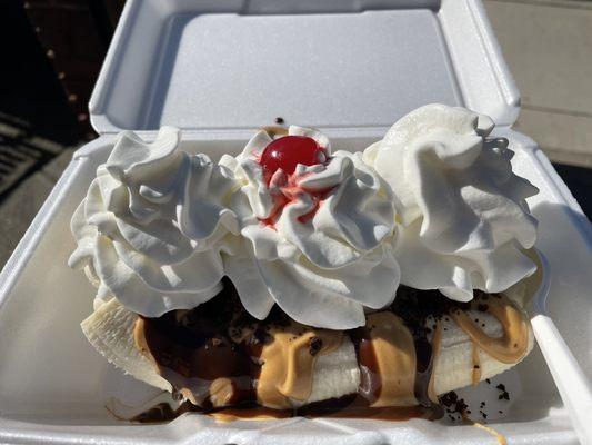 Banana Split with peanut butter swirl ice cream, peanut butter and chocolate topping along with cookie crumbles.