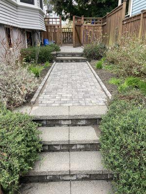 They power washed old retaining walls, added the paver path and edging.  Raised the path so the steps were safer.