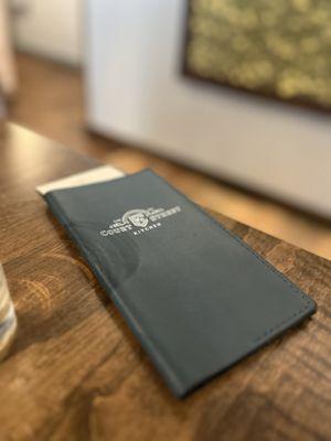 Love the detail... check book with the blue leather and restaurant's logo.