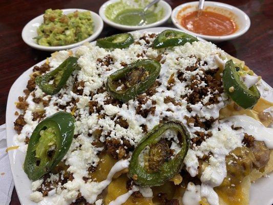 Nachos with carnitas Guacamole Salsa verde Secret orange sauce