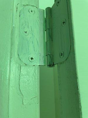 Poor quality work from installer 1 inch extended hinge from wooden door frame, attempting to fit door improperly.