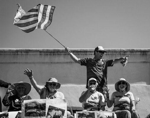 Trevor Quirk, Grand Marshall of the Ojai 4th of July Parade standing on the parade float with Fire Survivors