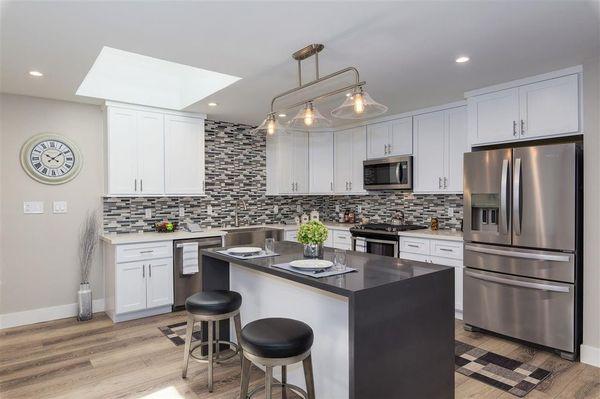 A happy customer's kitchen: Kingway Super White cabinet and waterfall style granite island