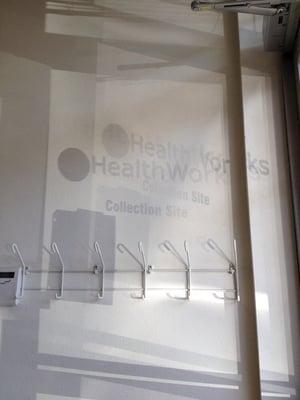 Reflection US HEALTHWORKS GLASS DOOR SIGNAGE SHADOW ON WALL