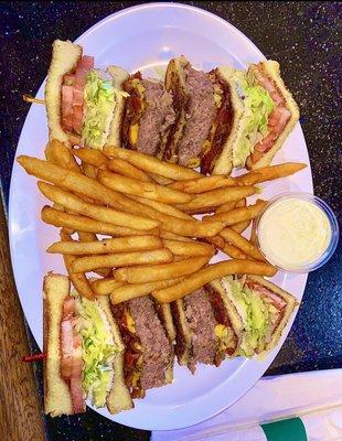 The "John's Cheeseburger Club" with a side of seasoned Fries.