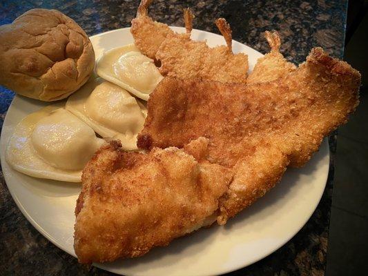 Large piece of fried cod, four butterflied shrimp, pierogies, and a roll with butter