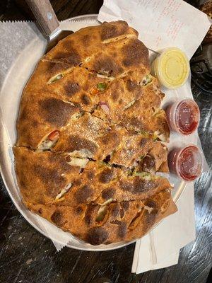 Medium calzone with a generous amount roasted chicken, bell peppers, roma tomato's and red onions.