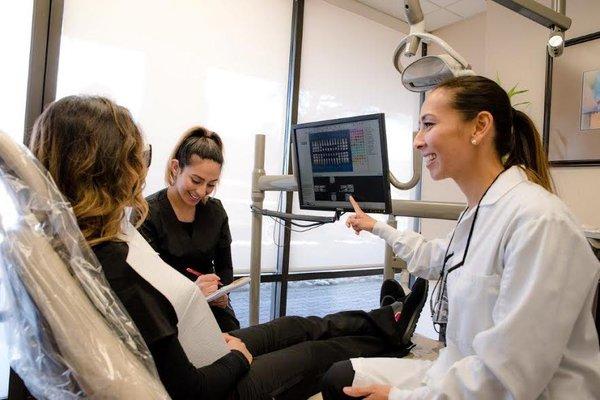 Dr. Vista and Mimi talking with a patient.