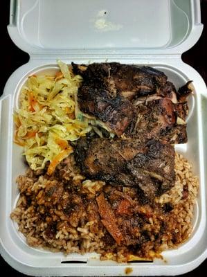 Jerk chicken lunch, rice and peas with brown stew gravy, steamed cabbage.