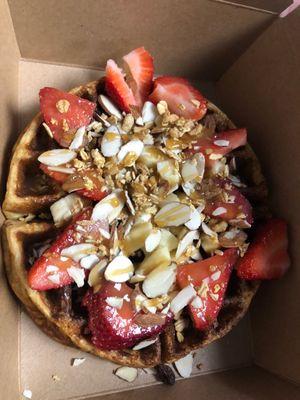 Waffle with strawberries nuts and honey drizzle