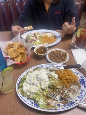 enchiladas and flauta plates with some drinks on the side, so delicious! the portions are huge