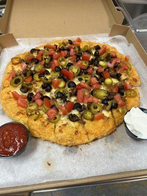 Delicious Taco Madness Pizza with Cheddar Crust. Served with a side of sour cream and salsa