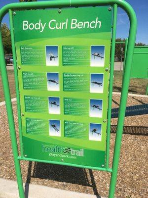 There is a station near the concrete walking trail. It claims you can do three activities there. Includes body curls.