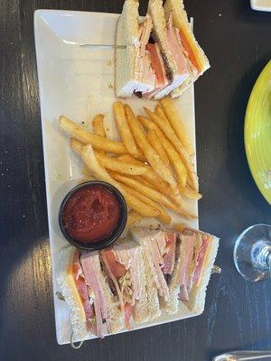 Club sandwich with American cheese, battered fries.