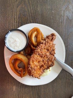 Chicken fried chicken with onion rings.