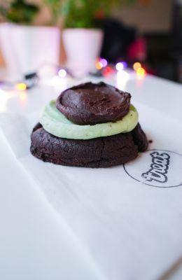 Alicia -A chocolate brownie sugar cookie topped with layers of mint & chocolate buttercream frosting. (September special)