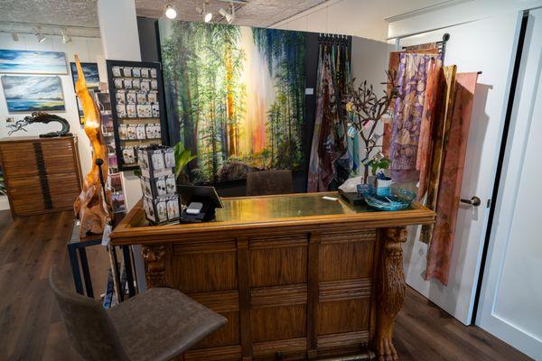 Front desk featuring A painting by Martina Goldberg, and jewelry by Karina Mendoza-Wittke