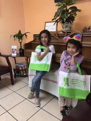 Charlotte and Charlize patiently waiting for their older sister and enjoying their beautiful bags.