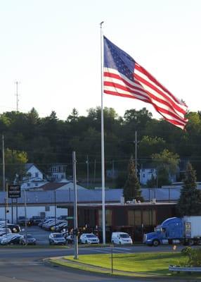 DeMaagd GMC Nissan Showroom with American Flag.