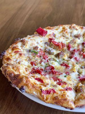 Breakfast Pizza: Alfredo sauce, mozzarella cheese, scrambled eggs, roasted red bell peppers and Italian sausage. Served on Sundays 11-2.