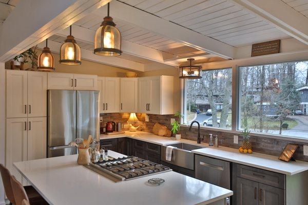 Kitchen remodel with white granite countertop and stainless steel appliances